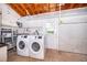 This laundry room offers shelving and modern machines at 2809 Sanbina St, Winter Park, FL 32789