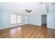 Inviting living room with modern flooring, ceiling fan, and a freshly painted accent wall at 2809 Sanbina St, Winter Park, FL 32789