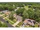 Aerial view of the home on a tree-lined street in a suburban community at 2823 Ne 24Th Pl, Ocala, FL 34470