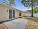 View of the back patio area with sliding glass door access and white vinyl fencing at 2823 Ne 24Th Pl, Ocala, FL 34470