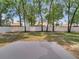 Large backyard with a concrete patio, white fence, and mature trees at 2823 Ne 24Th Pl, Ocala, FL 34470