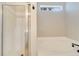 Modern bathroom featuring a clear glass shower and soaking tub under a window at 2823 Ne 24Th Pl, Ocala, FL 34470