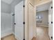 Bathroom featuring a tub-shower and wood-look floors leading to a bedroom at 2823 Ne 24Th Pl, Ocala, FL 34470