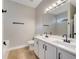 Bathroom featuring double vanity, modern fixtures, and a large mirror with vanity lighting at 2823 Ne 24Th Pl, Ocala, FL 34470