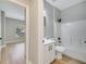 Bright bathroom featuring white cabinets, modern fixtures, and a shower-tub combo at 2823 Ne 24Th Pl, Ocala, FL 34470