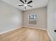 Neutral bedroom with wood-look floors, ceiling fan, and window at 2823 Ne 24Th Pl, Ocala, FL 34470