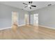 Spacious bedroom featuring light wood floors, a ceiling fan, and multiple doorways at 2823 Ne 24Th Pl, Ocala, FL 34470