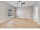 Bright, neutral bedroom with a ceiling fan, a large window, and wood-look flooring at 2823 Ne 24Th Pl, Ocala, FL 34470