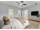 Spacious main bedroom with a ceiling fan, hardwood floors and ensuite bath at 2823 Ne 24Th Pl, Ocala, FL 34470