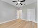 Bedroom with wood-look flooring, a ceiling fan, closet, and neutral paint at 2823 Ne 24Th Pl, Ocala, FL 34470