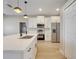 Well-equipped kitchen with stainless steel appliances, white cabinets, and a center island at 2823 Ne 24Th Pl, Ocala, FL 34470