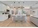 Modern kitchen featuring white cabinets, stainless steel appliances, and a central island with seating at 2823 Ne 24Th Pl, Ocala, FL 34470