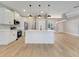 Open kitchen with white cabinets and stainless steel appliances, showcasing a kitchen island at 2823 Ne 24Th Pl, Ocala, FL 34470