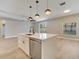 Open-concept kitchen features a large island with a sink and modern pendant lighting at 2823 Ne 24Th Pl, Ocala, FL 34470