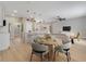 Bright and open-concept living and dining area with modern pendant lighting and kitchen island at 2823 Ne 24Th Pl, Ocala, FL 34470