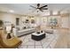 Airy open-concept living space featuring a large area rug, modern furnishings, and hardwood flooring at 2823 Ne 24Th Pl, Ocala, FL 34470