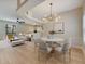 Bright open-concept living space featuring hardwood flooring, modern furnishings, and modern chandelier at 2823 Ne 24Th Pl, Ocala, FL 34470