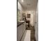 Bright bathroom featuring a shower-tub combination, vanity with shelving, and wood-look floors at 31701 State Road 44 Sr-44, Eustis, FL 32736