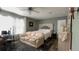 Cozy bedroom with a seating area, decorative headboard, and ample natural light, creating a relaxing retreat at 31701 State Road 44 Sr-44, Eustis, FL 32736
