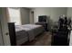 Bedroom featuring a large window, wood-look floors, and neutral-toned walls at 31701 State Road 44 Sr-44, Eustis, FL 32736