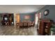 Formal dining room with a long table and chairs, complemented by classic decor and wood-look flooring at 31701 State Road 44 Sr-44, Eustis, FL 32736