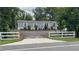 Charming single-story home with gray siding, a graveled yard, and a white picket fence at 31701 State Road 44 Sr-44, Eustis, FL 32736
