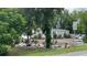 Home exterior with mature trees and a gravel drive at 31701 State Road 44 Sr-44, Eustis, FL 32736