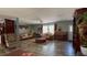 Inviting living room featuring a ceiling fan, comfortable seating, and bright natural light from the large windows at 31701 State Road 44 Sr-44, Eustis, FL 32736