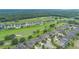 Aerial view featuring residential neighborhood bordering a lush green golf course at 31961 Redtail Reserve Blvd, Sorrento, FL 32776