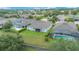 Aerial view of a home with solar panels and a screened-in pool at 31961 Redtail Reserve Blvd, Sorrento, FL 32776