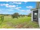 Expansive backyard with lush green grass, mature trees, and a view of neighboring homes at 31961 Redtail Reserve Blvd, Sorrento, FL 32776