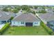 Aerial view showcasing a house with a well-manicured lawn, and a screened porch at 31961 Redtail Reserve Blvd, Sorrento, FL 32776