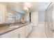 Bathroom with dual sinks, modern fixtures, and a luxurious soaking tub at 31961 Redtail Reserve Blvd, Sorrento, FL 32776