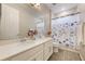 Bathroom with double sinks, a large mirror, and shower with blue flower curtain at 31961 Redtail Reserve Blvd, Sorrento, FL 32776
