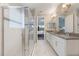 Bright bathroom featuring a double vanity, marble floors, and glass enclosed shower at 31961 Redtail Reserve Blvd, Sorrento, FL 32776