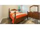 Bright bedroom featuring wood-look flooring, classic wood furniture, and a sunny window at 31961 Redtail Reserve Blvd, Sorrento, FL 32776
