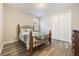 Bedroom with wood-look flooring, closet, and metal bedframe, and natural light at 31961 Redtail Reserve Blvd, Sorrento, FL 32776