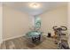 Bedroom with wood-look floors, natural light, and a charming train table and exercise bike at 31961 Redtail Reserve Blvd, Sorrento, FL 32776