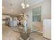 Breakfast nook with a glass table, modern chandelier, and natural light, adjacent to the kitchen at 31961 Redtail Reserve Blvd, Sorrento, FL 32776