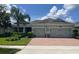 Charming single-story home with a two-car garage, landscaped yard, and a brick driveway at 31961 Redtail Reserve Blvd, Sorrento, FL 32776