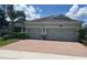 Charming single-story home with a two-car garage and a brick driveway at 31961 Redtail Reserve Blvd, Sorrento, FL 32776