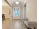 Open foyer with a decorative front door and a view into the dining and living spaces at 31961 Redtail Reserve Blvd, Sorrento, FL 32776