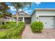 Welcoming entrance with meticulously maintained bushes and a charming brick pathway leading to the front door at 31961 Redtail Reserve Blvd, Sorrento, FL 32776