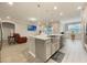 Open-concept kitchen features an island, granite countertops, stainless appliances, and seamless flow to living area at 31961 Redtail Reserve Blvd, Sorrento, FL 32776