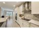 Updated kitchen with stainless steel appliances, white cabinets, and a mosaic backsplash at 31961 Redtail Reserve Blvd, Sorrento, FL 32776