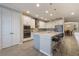 Modern kitchen with white cabinets, a large island, stainless steel appliances, and bar stool seating at 31961 Redtail Reserve Blvd, Sorrento, FL 32776