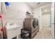 Convenient laundry room featuring new washer and dryer, a utility sink, and wood-look flooring at 31961 Redtail Reserve Blvd, Sorrento, FL 32776