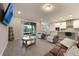 Bright living room with tile floors, comfortable seating, and sliding glass doors to the outdoor space at 31961 Redtail Reserve Blvd, Sorrento, FL 32776