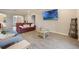 Comfortable living room featuring tile flooring, a leather sofa, and a large-screen TV at 31961 Redtail Reserve Blvd, Sorrento, FL 32776