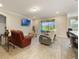 Open-concept living area with a sliding glass door leading to a patio, and tile flooring throughout at 31961 Redtail Reserve Blvd, Sorrento, FL 32776